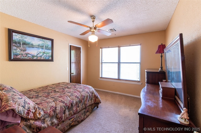 bedroom featuring baseboards, carpet flooring, a textured ceiling, and visible vents