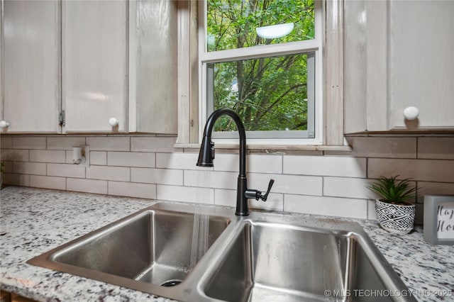 room details featuring a sink and backsplash