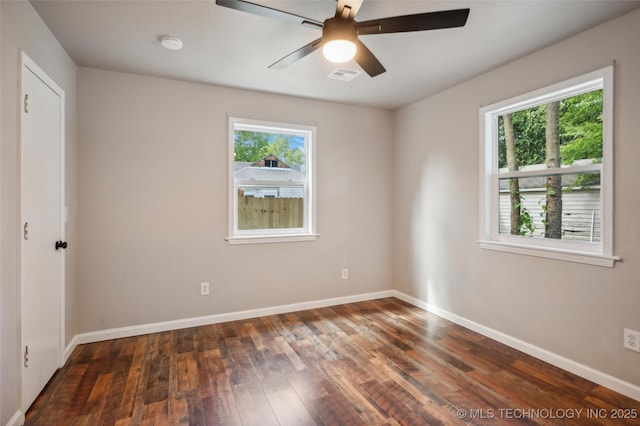 spare room featuring baseboards, a ceiling fan, hardwood / wood-style flooring, and visible vents