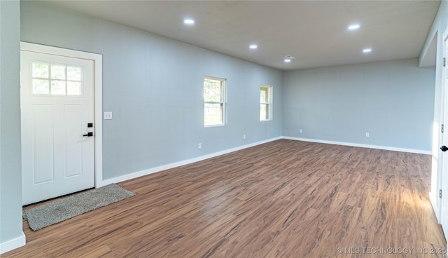 foyer featuring recessed lighting, plenty of natural light, and wood finished floors