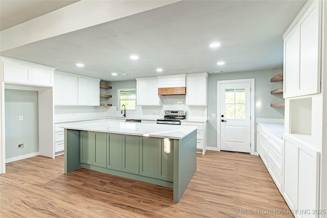 kitchen featuring light wood-type flooring, white cabinets, open shelves, and electric range