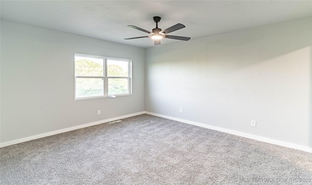 empty room with baseboards, a ceiling fan, and carpet flooring