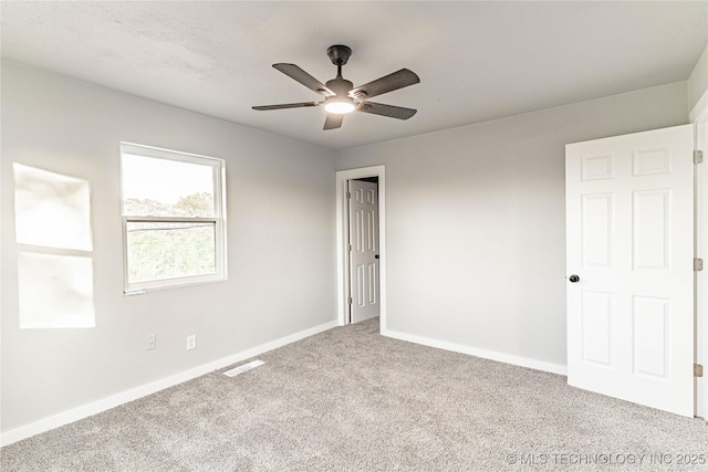 unfurnished bedroom featuring baseboards, ceiling fan, carpet flooring, and visible vents