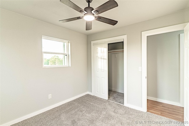 unfurnished bedroom with baseboards, ceiling fan, carpet, and a closet