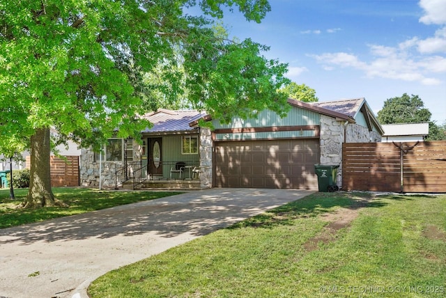 4604 Maple Dr, Sand Springs, OK 74063 - view of front of property with a garage, fence, stone siding, metal roof, and driveway