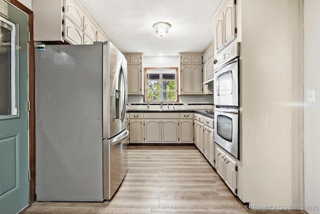 4604 Maple Dr, Sand Springs, OK 74063 - kitchen featuring appliances with stainless steel finishes, a sink, and light wood-style floors