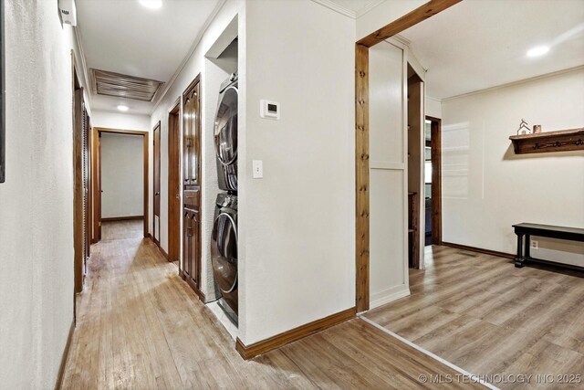 4604 Maple Dr, Sand Springs, OK 74063 - corridor with light wood-style flooring, baseboards, stacked washer / dryer, visible vents, and ornamental molding