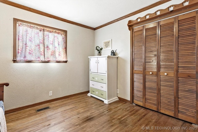 4604 Maple Dr, Sand Springs, OK 74063 - unfurnished bedroom with visible vents, crown molding, a closet, wood finished floors, and baseboards