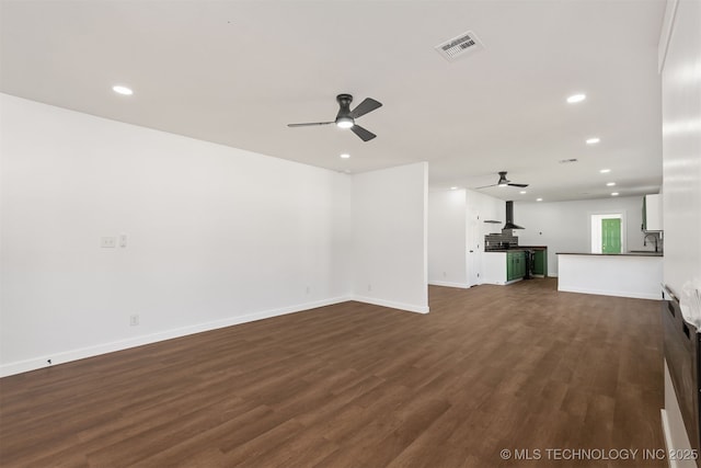 unfurnished living room with recessed lighting, ceiling fan, visible vents, and dark wood-style floors