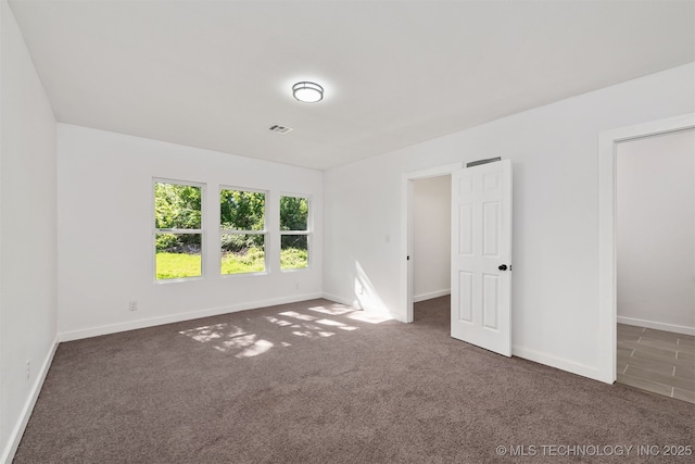 carpeted empty room with baseboards and visible vents