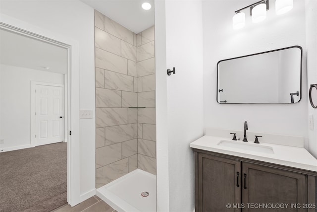 full bathroom with vanity, baseboards, and a stall shower