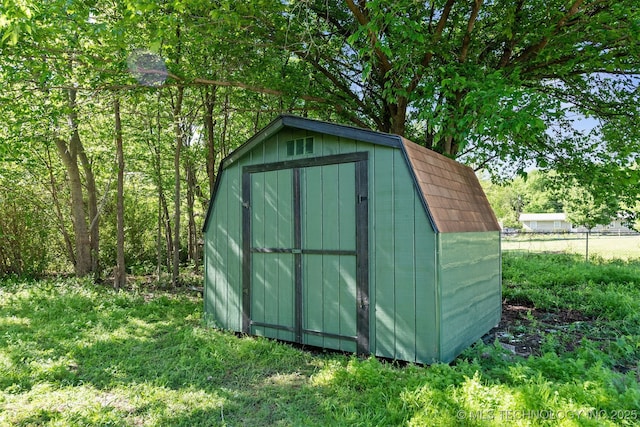 view of shed featuring fence