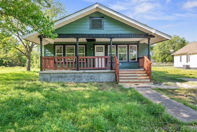 bungalow featuring covered porch and central AC