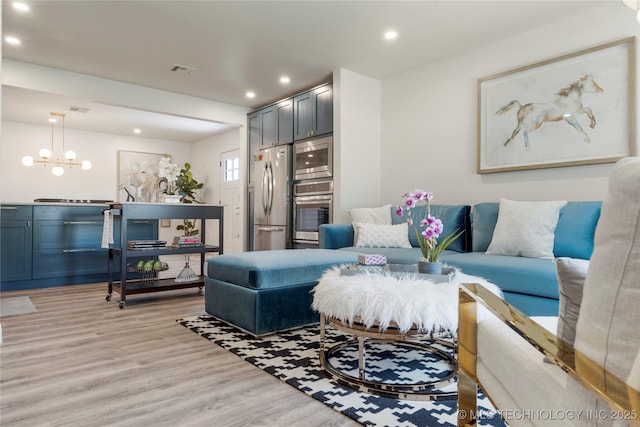 living area featuring recessed lighting, visible vents, a chandelier, and light wood-style floors