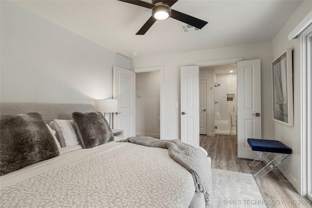 bedroom featuring baseboards, ceiling fan, wood finished floors, and visible vents