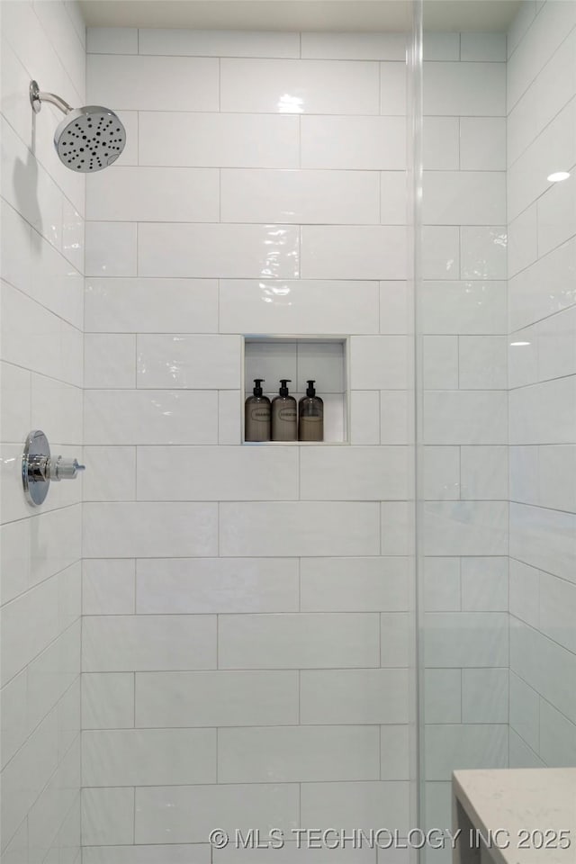 bathroom with tiled shower