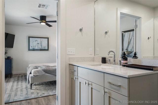 bathroom with visible vents, vanity, wood finished floors, ensuite bathroom, and ceiling fan
