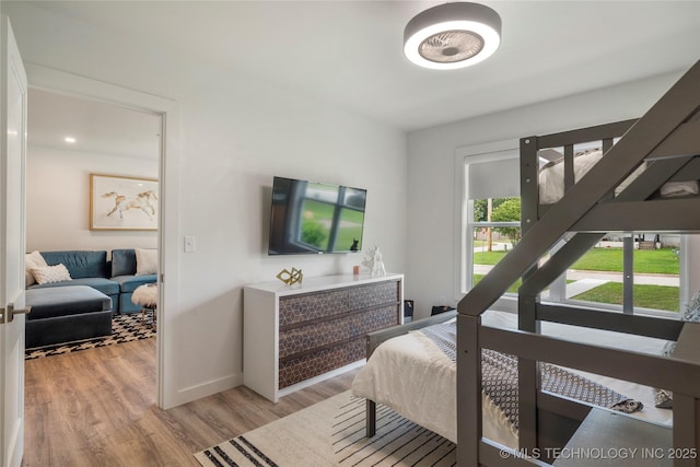bedroom featuring baseboards and wood finished floors