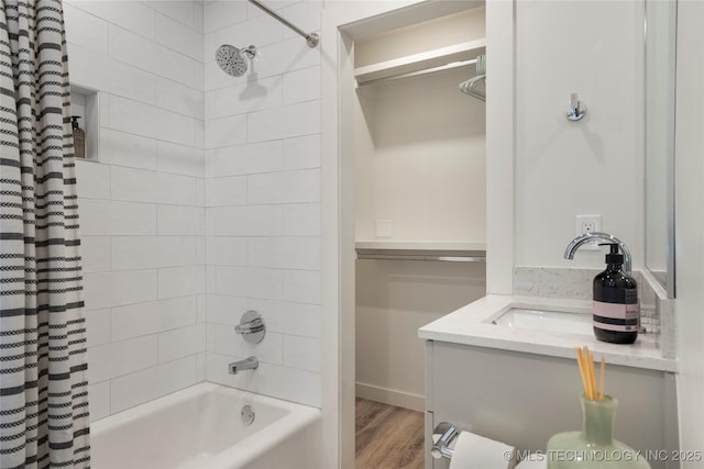 full bath featuring a sink, shower / bathtub combination with curtain, and wood finished floors