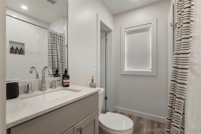 full bathroom featuring vanity, wood finished floors, curtained shower, toilet, and recessed lighting