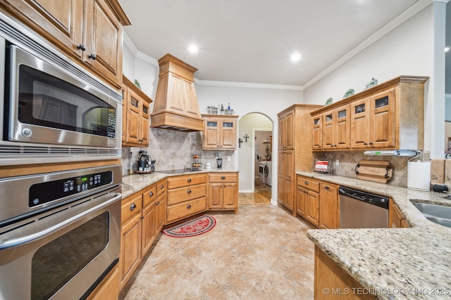 kitchen featuring light stone counters, decorative backsplash, and appliances with stainless steel finishes