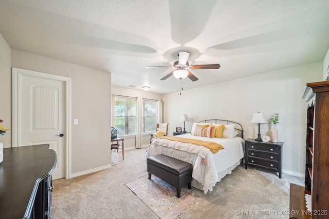 bedroom featuring a ceiling fan, baseboards, and light colored carpet