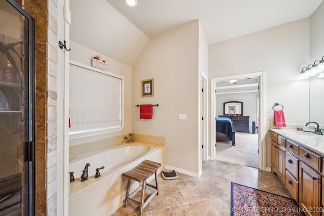 ensuite bathroom with a bath, a shower stall, vanity, baseboards, and ensuite bathroom