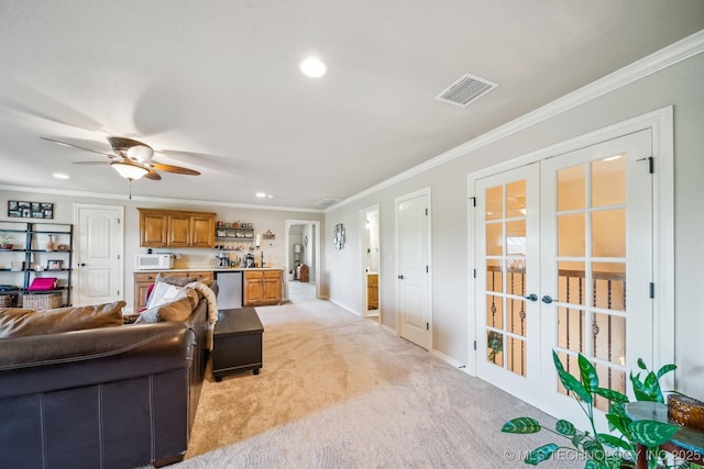 living room with visible vents, ornamental molding, recessed lighting, light colored carpet, and french doors