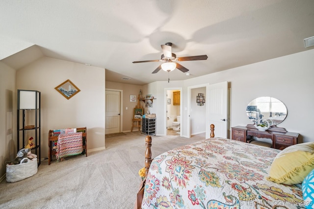 carpeted bedroom featuring ceiling fan, visible vents, baseboards, and ensuite bath