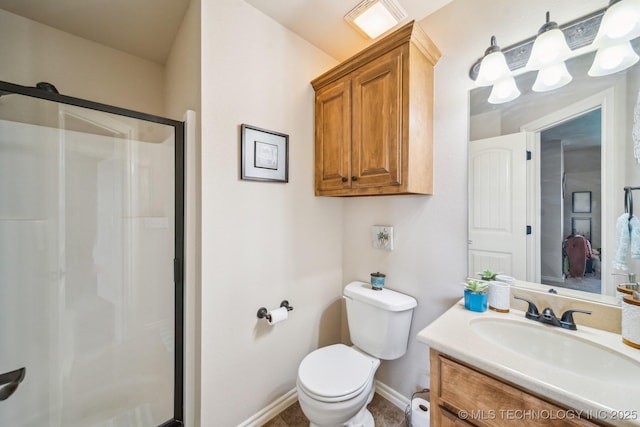 full bathroom with baseboards, a stall shower, toilet, and vanity