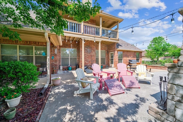 view of patio / terrace featuring area for grilling and a balcony