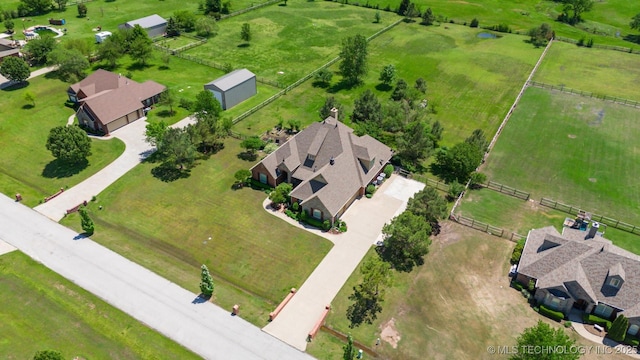 birds eye view of property with a rural view