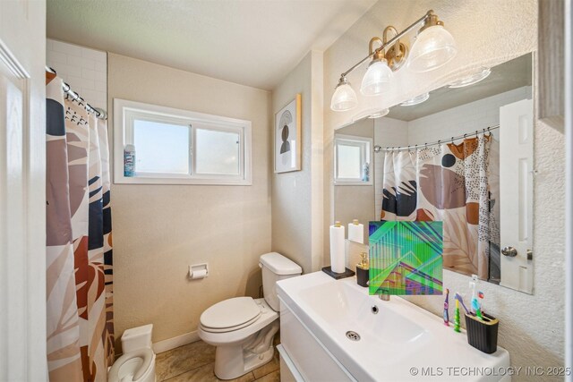 750 N Xenophon Ave, Tulsa, OK 74127 - bathroom with a shower with curtain, vanity, tile patterned floors, baseboards, and toilet