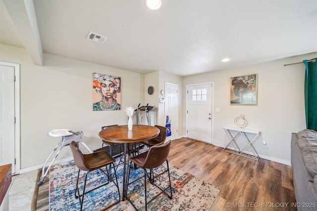 dining area with baseboards, recessed lighting, wood finished floors, and visible vents