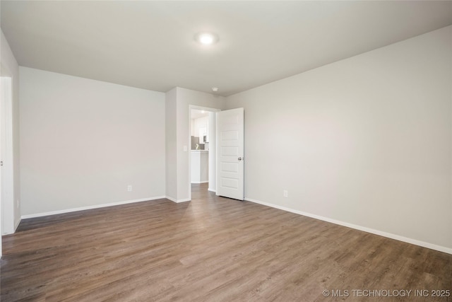 29327 E 80th St SE, Broken Arrow, OK 74014 - unfurnished bedroom featuring baseboards and wood finished floors