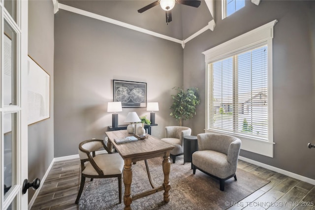 sitting room with ceiling fan, baseboards, plenty of natural light, and wood finished floors