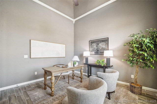 office area with a ceiling fan, baseboards, a high ceiling, and wood tiled floor