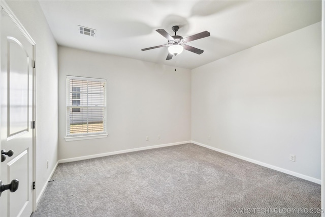 empty room with baseboards, a ceiling fan, carpet flooring, and visible vents