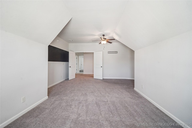 bonus room featuring baseboards, carpet flooring, ceiling fan, and lofted ceiling