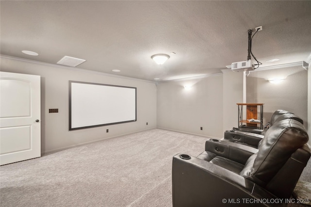 carpeted home theater featuring visible vents, ornamental molding, and baseboards