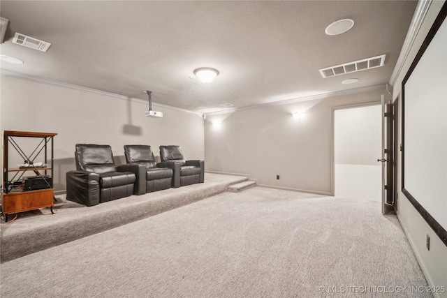 carpeted cinema room featuring baseboards, visible vents, and ornamental molding