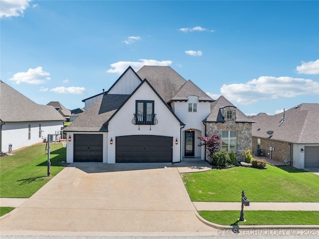 view of front of property with a front yard, a garage, concrete driveway, stone siding, and stucco siding
