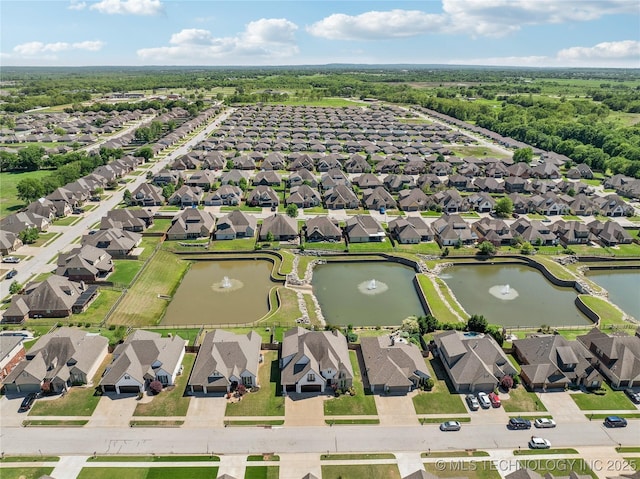 birds eye view of property with a water view and a residential view
