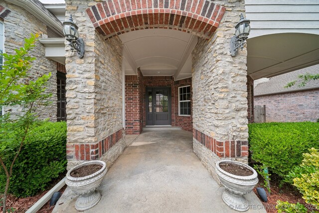 8655 E 103rd St, Tulsa, OK 74133 - entrance to property with brick siding and a porch