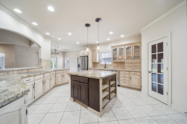 8655 E 103rd St, Tulsa, OK 74133 - kitchen featuring stainless steel refrigerator with ice dispenser, crown molding, backsplash, a sink, and light tile patterned floors