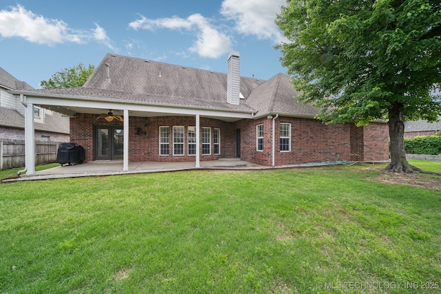 8655 E 103rd St, Tulsa, OK 74133 - back of property with a ceiling fan, a patio, brick siding, and a chimney