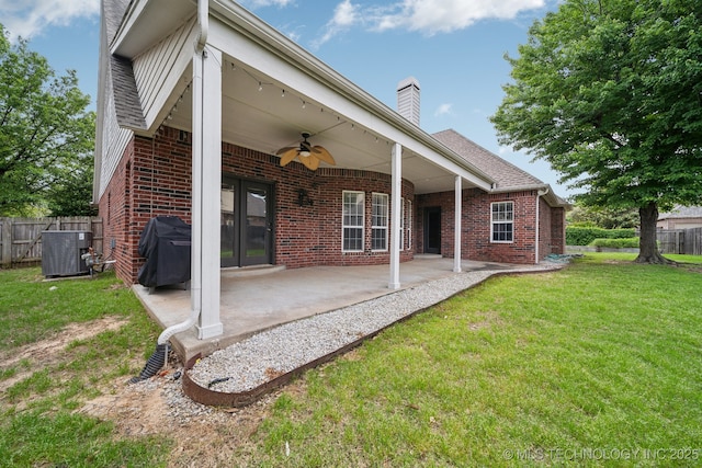 8655 E 103rd St, Tulsa, OK 74133 - rear view of property featuring a ceiling fan, brick siding, central AC, a chimney, and a patio area