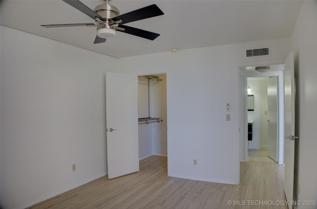 unfurnished bedroom featuring baseboards, a ceiling fan, light wood-style flooring, and visible vents