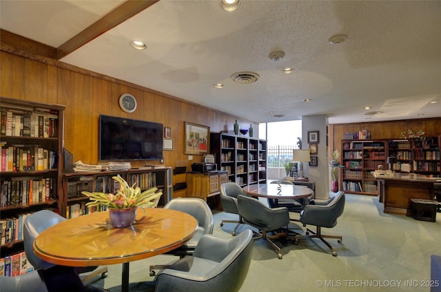 carpeted dining room with recessed lighting, wooden walls, and visible vents