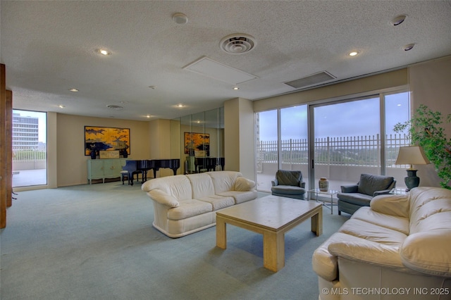 carpeted living room with recessed lighting, attic access, and a textured ceiling